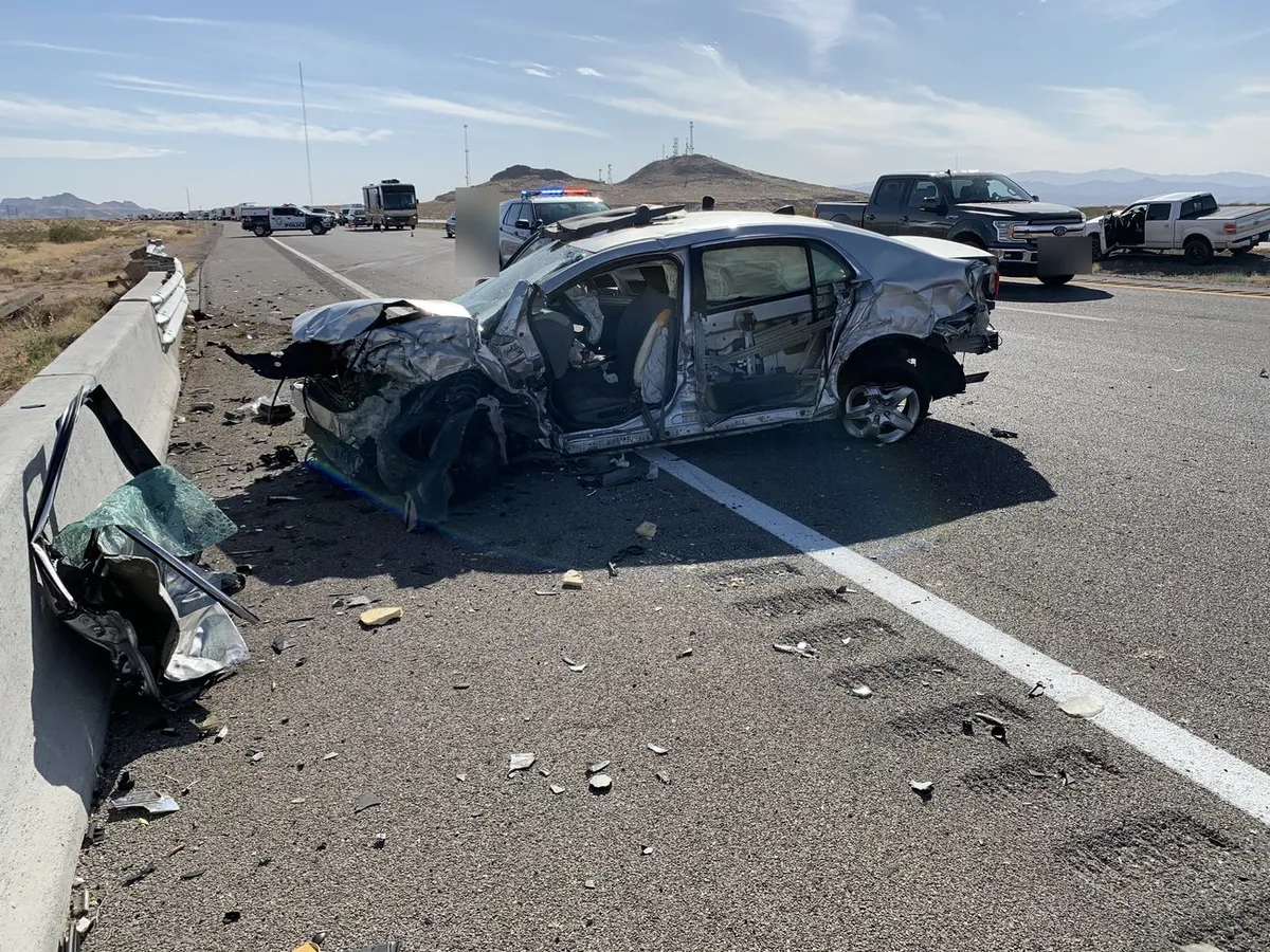 Interstate crash scene with heavy vehicle damage.